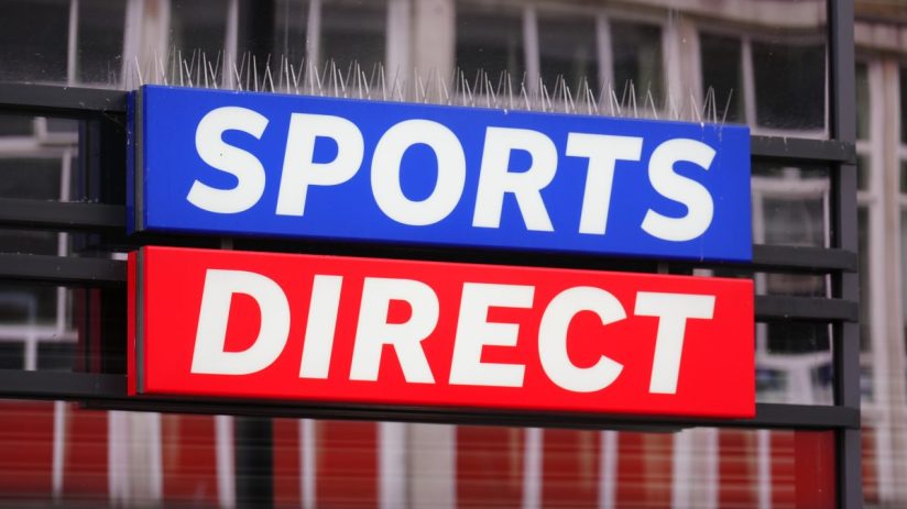 Sports Direct store sign with anti-pigeon spikes, showcasing the blue and red branding of the retail giant.