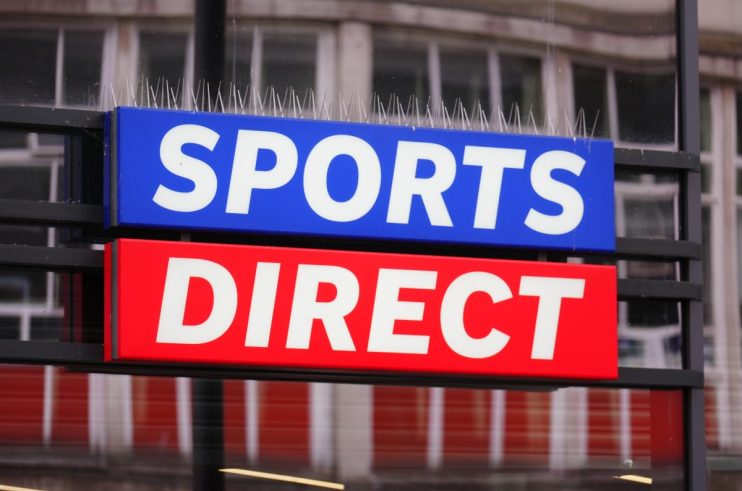 Sports Direct store sign with anti-pigeon spikes, showcasing the blue and red branding of the retail giant.