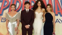 Florence Pugh, Tom Holland, Zendaya, and Marisa Tomei at a premiere event with a Spider-Man backdrop.