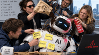 Three people sabotage a robot AI with bad data, spray paint, and tangling wires, causing system errors.
