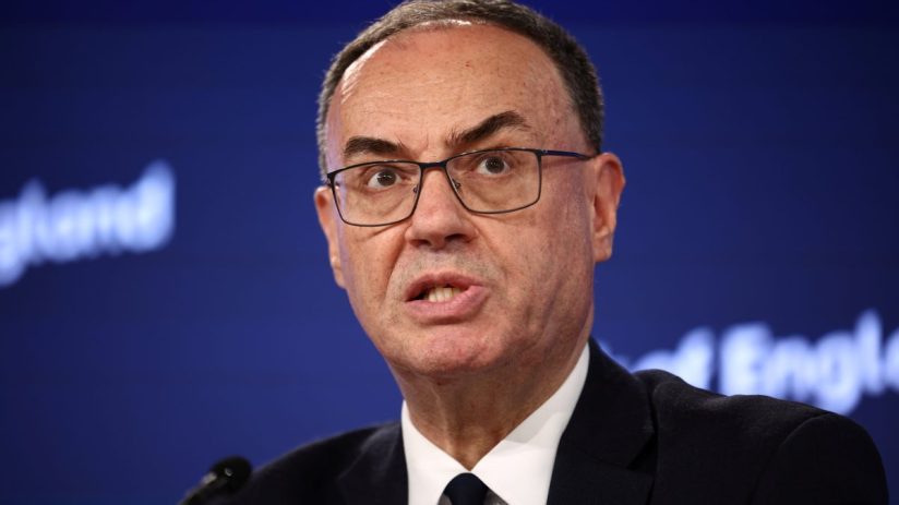 Andrew Bailey, Governor of the Bank of England, speaking at a press conference against a blue background