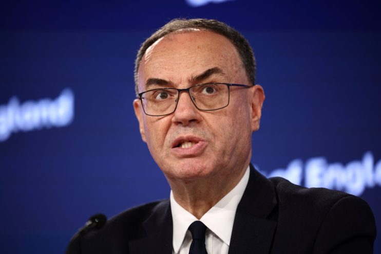 Andrew Bailey, Governor of the Bank of England, speaking at a press conference against a blue background