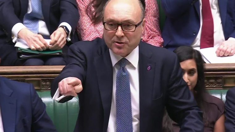 Andrew Griffith speaking passionately, pointing his finger, in a formal parliamentary setting.