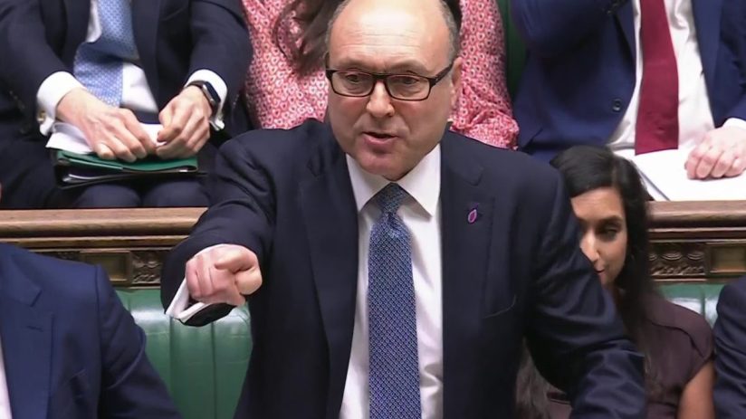 Andrew Griffith speaking passionately, pointing his finger, in a formal parliamentary setting.