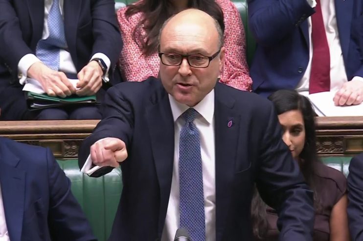 Andrew Griffith speaking passionately, pointing his finger, in a formal parliamentary setting.