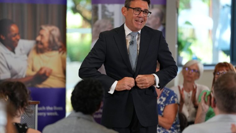 Andy Burnham speaks at Golders Green care home visit, September 2026, engaging with attendees.