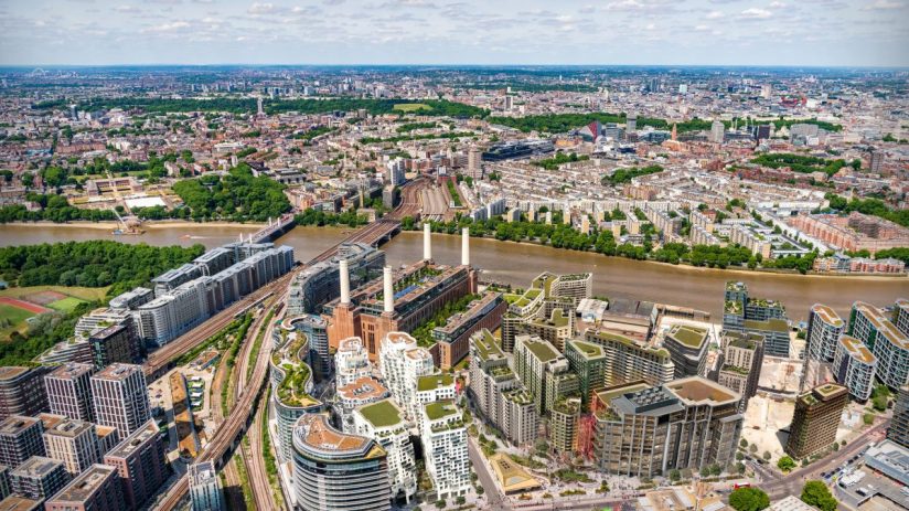 CGI rendering of Battersea Power Stations future development with new buildings and green spaces along the River Thames.