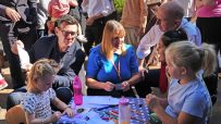 Andy Burnham and Tracy Brabin interacting with children at an outdoor event