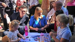 Andy Burnham and Tracy Brabin interacting with children at an outdoor event