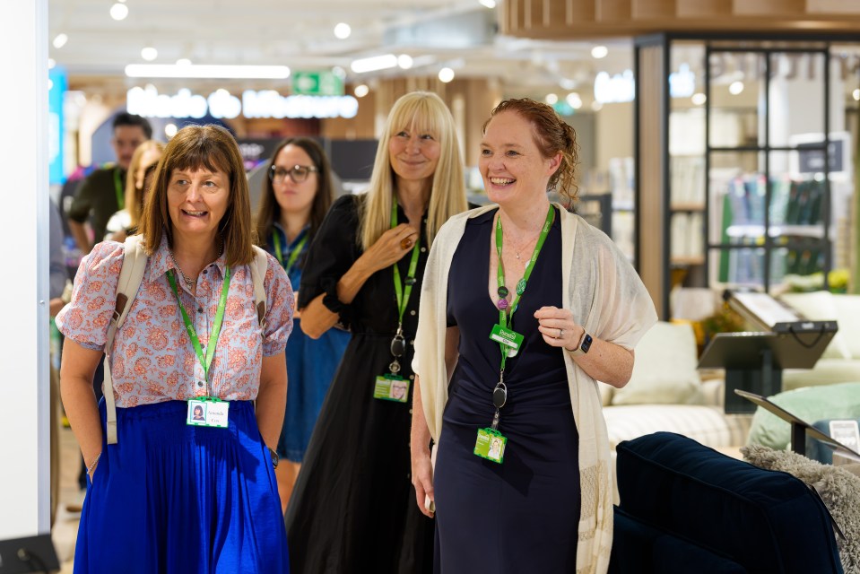 Dunelm CEO Clo Moriarty smiling with colleagues at the Kingston store opening event, wearing ID badges.