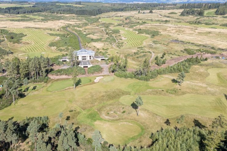 Aerial view of GWest Resort Perthshire golf course with clubhouse, green fairways, and surrounding woodland