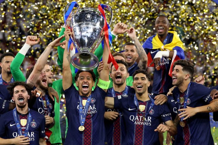 PSG players celebrate with the UEFA Champions League trophy and gold medals as confetti falls.