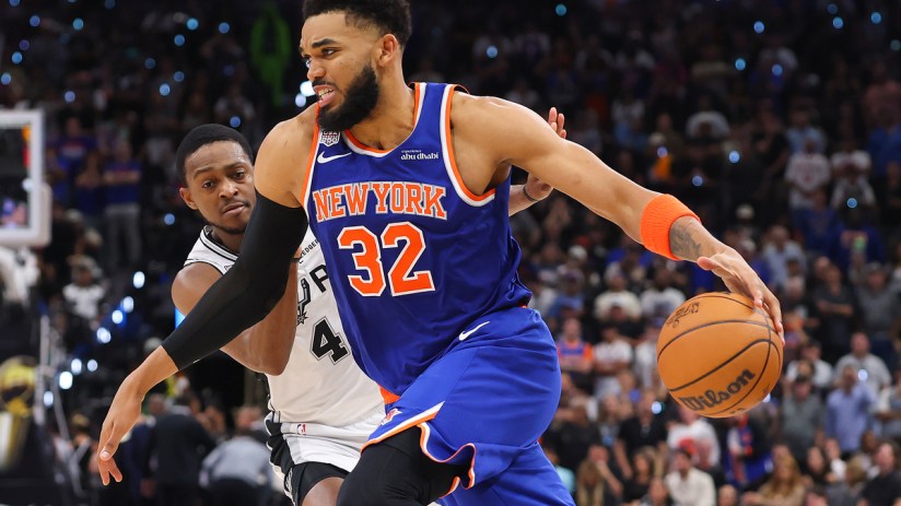 Miles McBride (New York Knicks) dribbling the basketball past an opponent from the San Antonio Spurs during a game