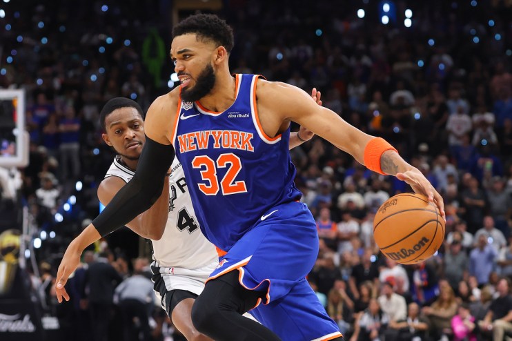 Miles McBride (New York Knicks) dribbling the basketball past an opponent from the San Antonio Spurs during a game
