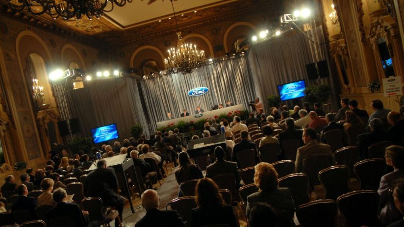 Attendees at a Ford Annual Shareholders Meeting in an ornate ballroom