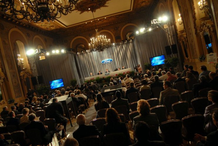 Attendees at a Ford Annual Shareholders Meeting in an ornate ballroom