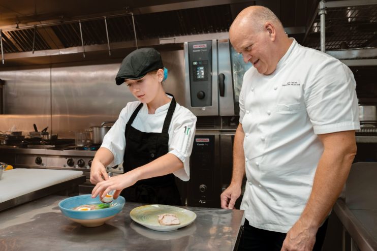 Hilton London Metropole young chef and Head Chef Paul Bates preparing a dish in the kitchen