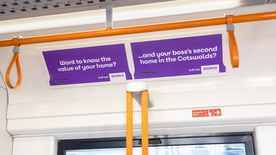 Zoopla advertising on a train, asking Want to know the value of your home? ...and your bosss second home in the Cotswolds?
