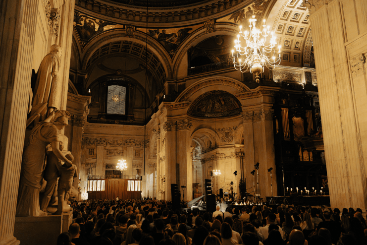 St Pauls Cathedral interior with an audience, grand architecture, chandeliers, and decorative fabric details