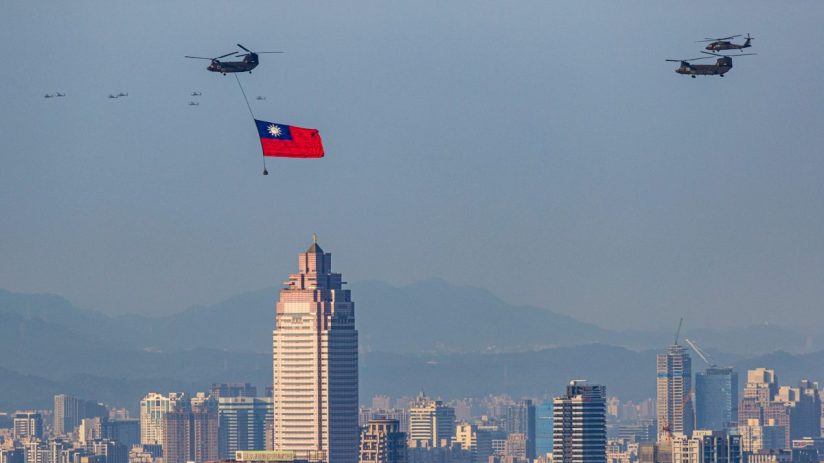 Taiwan flag flyover 2022 with military helicopters above a city skyline and mountains
