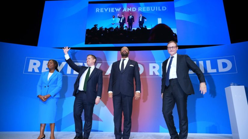 Kemi Badenoch, Tom Tugendhat, James Cleverly, and a Conservative MP on stage during a reshuffle event.