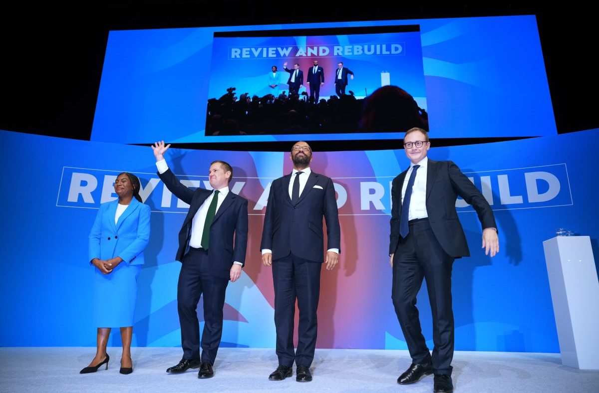 Kemi Badenoch, Tom Tugendhat, James Cleverly, and a Conservative MP on stage during a reshuffle event.