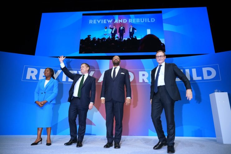 Kemi Badenoch, Tom Tugendhat, James Cleverly, and a Conservative MP on stage during a reshuffle event.
