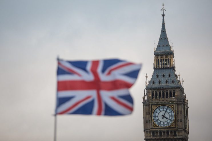 Union Jack flag in front of Elizabeth Tower (Big Ben), Houses of Parliament, London, UK