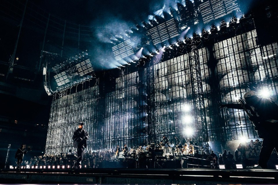 Jay-Z performing at Tottenham Hotspur Stadium, with a large stage and bright lights during a 2026 concert.