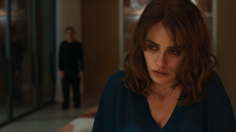 Pen&eacute;lope Cruz with a worried expression, a blurry man in the background, likely from a Venice Film Festival film.