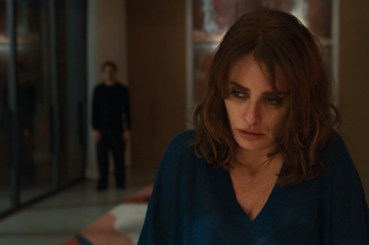 Pen&eacute;lope Cruz with a worried expression, a blurry man in the background, likely from a Venice Film Festival film.