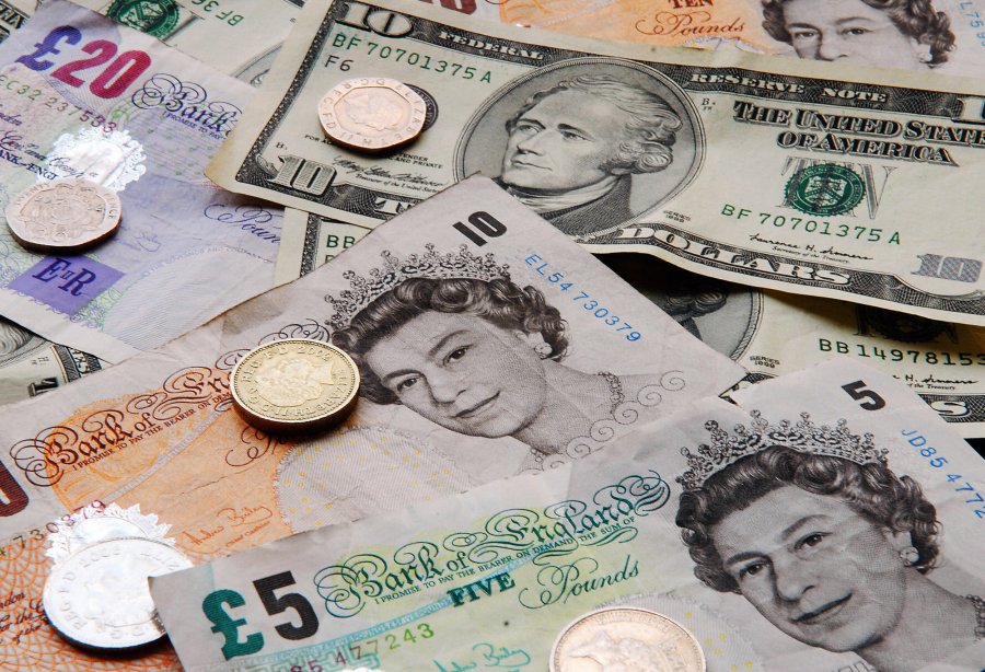 Pound coins and notes with dollars